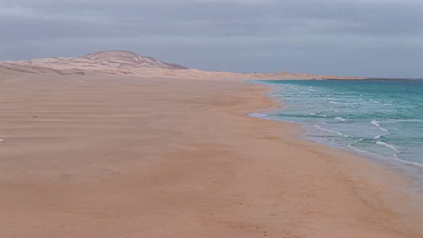 Drone view of Chaves beach at sunny day, sandy beach and turquoise ocean.Panning view of the amazing beach,,summer concept, Boa Vista, Cape Verde.