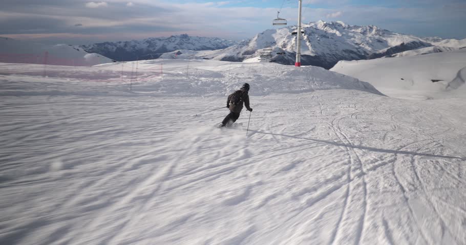 Skiing in the Alps, skier going fast descending, dynamic follow shot point of view