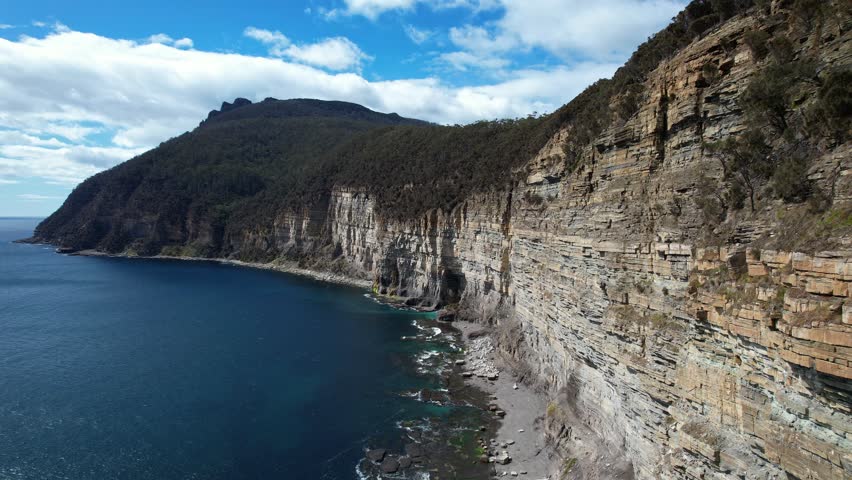 Fossil Bay Cliffs Over Turquoise Ocean, Tasmania, Australia - drone shot