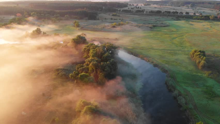 Sunrise over a misty river, capturing serene natural beauty, soft morning light, fog, and peaceful water landscapes in a tranquil outdoor setting.