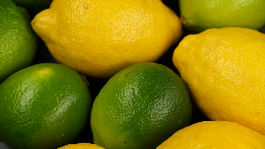 Whole citrus lemons and limes close up, rotate