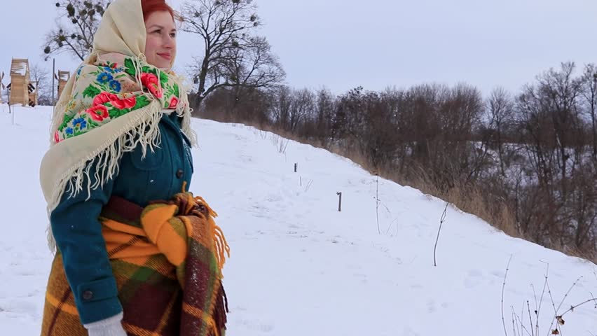 Beautiful girl with red hair in a traditional scarf winter portrait