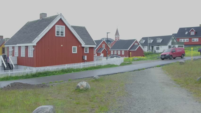 Nuuk Greenland 2025 city streets with Greenland flag and white picket fences.