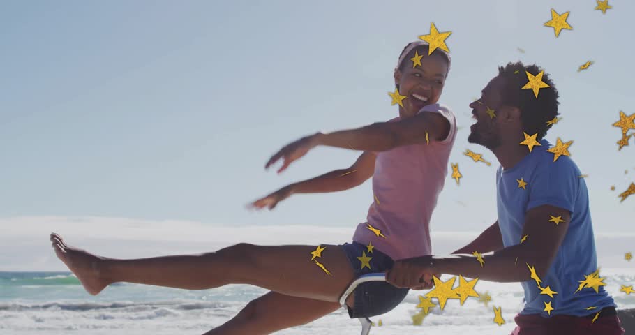 Couple posing on yellow bike at beach, sharing glance and initiating star confetti for marketing. Romance, leisure, adventure, outdoor, vibrant, joyful, companionship