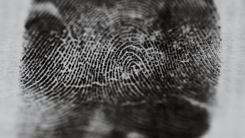 A detailed view of a fingerprint on a piece of paper, ideal for use in detective or crime scene investigations.