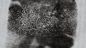 A detailed view of a fingerprint on a piece of paper, ideal for use in detective or crime scene investigations. - Powered by Shutterstock - Get 15% off with code: PIKWIZARD15