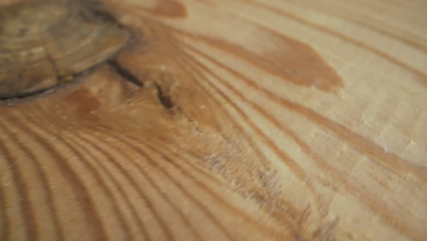Extreme close-up of a pile of shelled walnuts appearing and disappearing on a textured wooden board. Healthy eating and nutritious food concepts