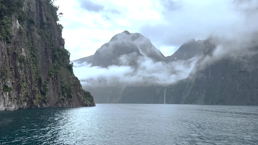 Milford Sound view over the water. New Zealand famous fjord with dramatic peaks and waterfall