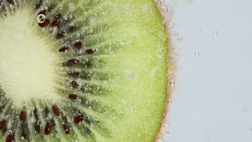 Kiwi fruit with bubbles floating up one after another