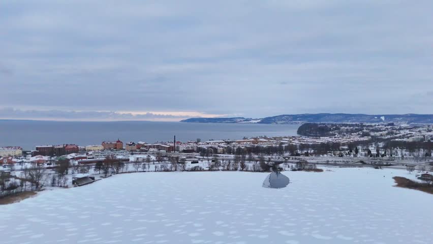 Snowy Coastal Town Aerial View in Winter.