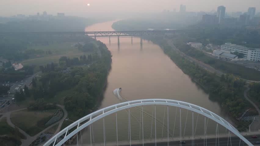 Aerial View of Smoky River and Bridge at Sunset.