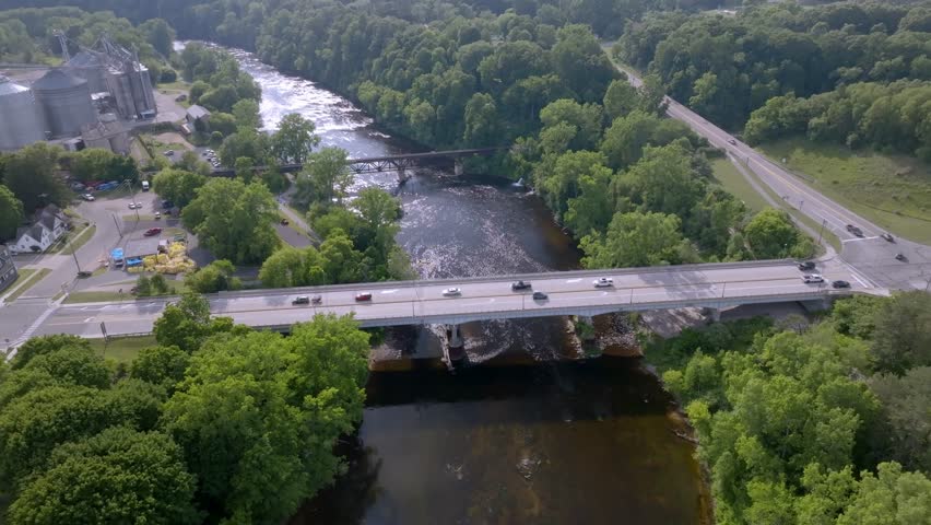 Bridge over Muskegon River in Newaygo, Michigan with stable drone video.