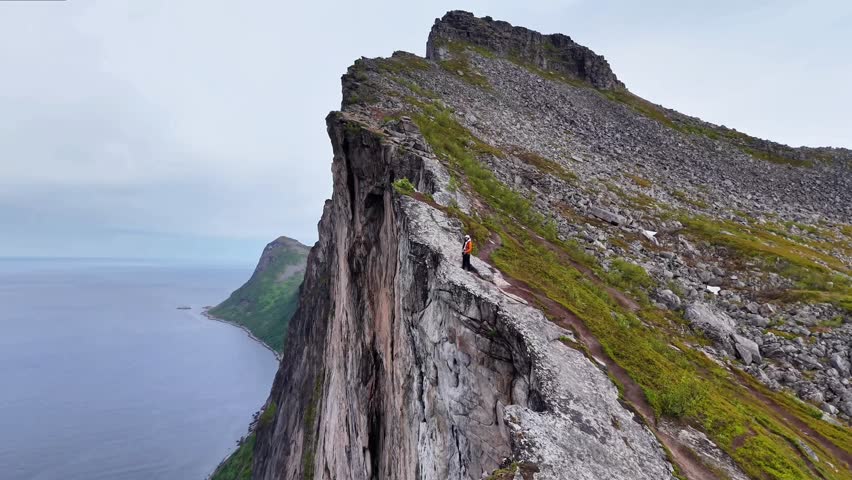 Majestic seaside cliff with sweeping horizon and breeze. Rugged oceanfront cliff with expansive vista and gusty ambiance
