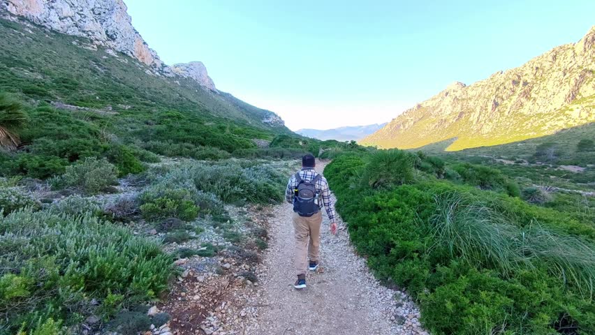 Man Hiking on Scenic Mountain Trail Towards Cala Boquer in Mallorca