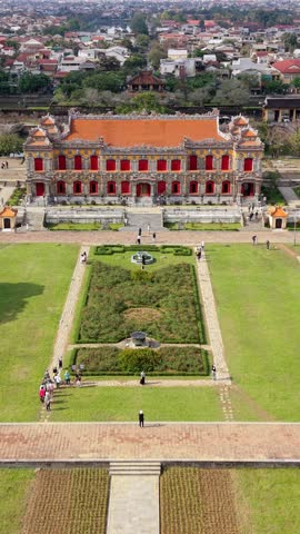 Aerial view of the Imperial City of Hue, Vietnam, revealing historic palace architecture, surrounding gardens, city walls, river, and urban landscape of central Vietnam.