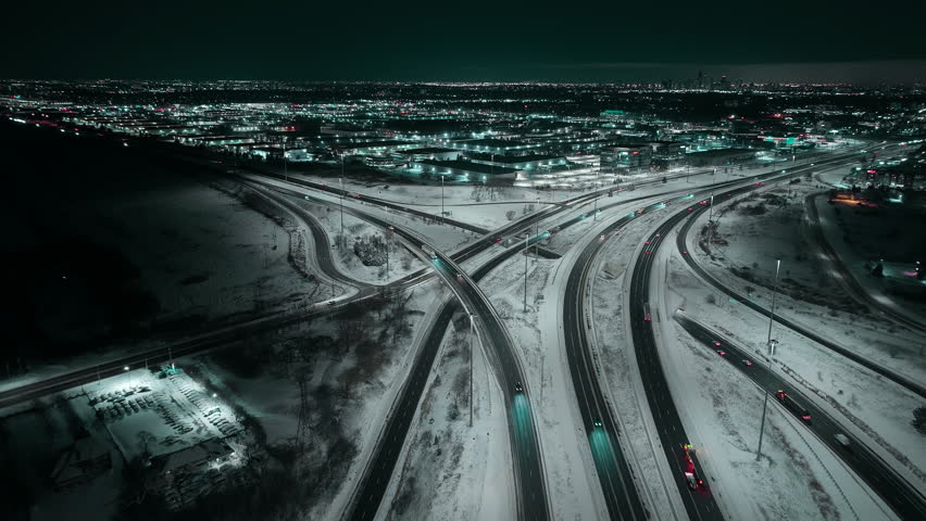 Night aerial view of snowy Mississauga 403 and QEW freeway interchange