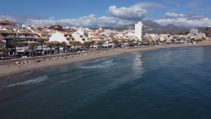 Flying alongside the beachfront of El Campello, Spain