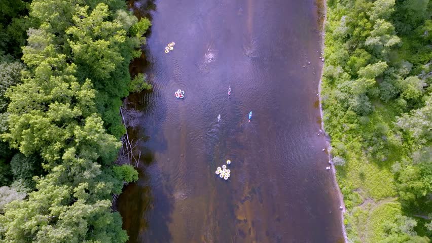 Kayakers in Muskegon River in Newaygo, Michigan with drone video overhead.