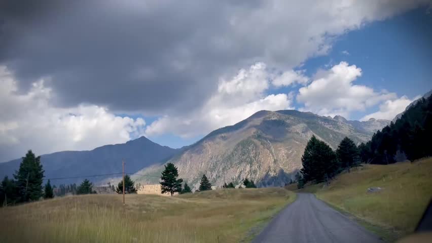 Supreme road trip view of mountains and country road. Livingston, MT. August 2025. 