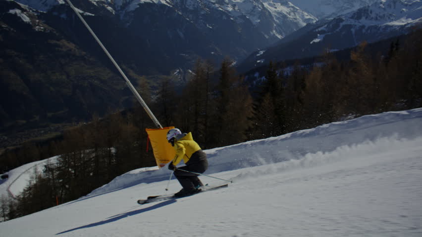 High performance alpine ski carving on groomed pistes in Verbier Bruson and Val de Bagnes filmed with drone and follow cam on a bluebird winter day showcasing fast dynamic fun skiing.