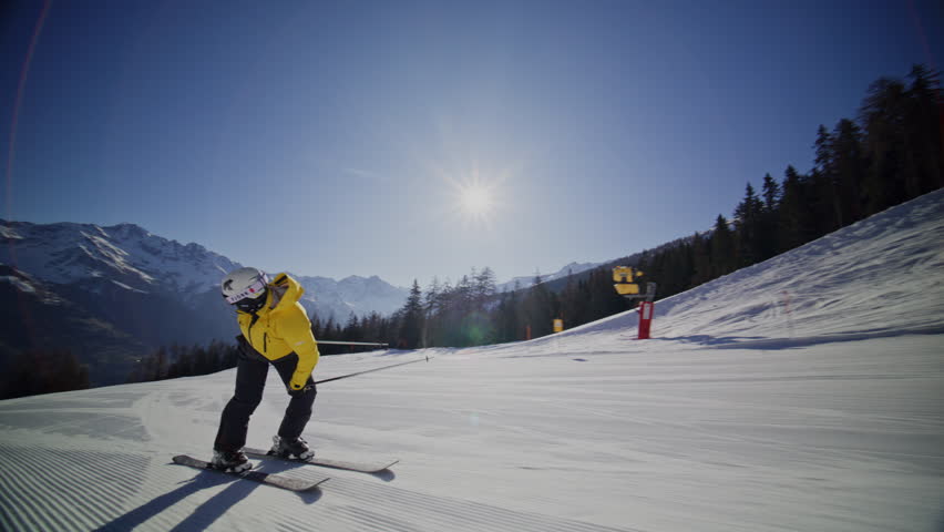 High performance alpine ski carving on groomed pistes in Verbier Bruson and Val de Bagnes filmed with drone and follow cam on a bluebird winter day showcasing fast dynamic fun skiing.