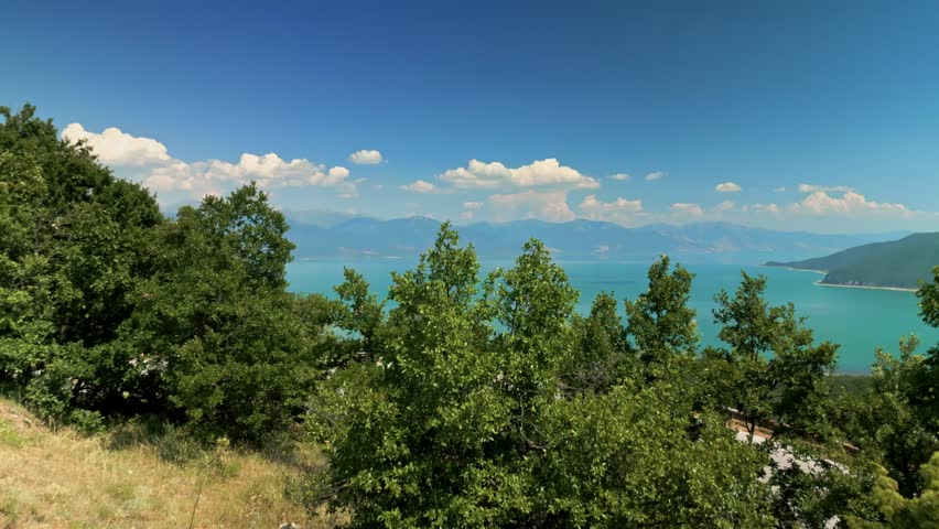 Aerial drone footage of Lake Prespa in North Macedonia. Scenic view of a large freshwater lake surrounded by mountains and natural landscape. Peaceful protected area in the Balkans, known for rich wildlife, wetlands and unspoiled nature.