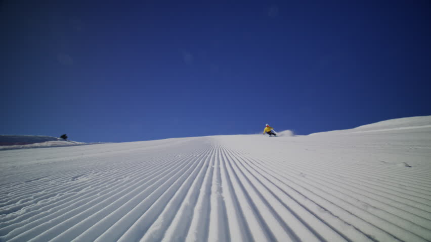 High performance alpine ski carving on groomed pistes in Verbier Bruson and Val de Bagnes filmed with drone and follow cam on a bluebird winter day showcasing fast dynamic fun skiing.