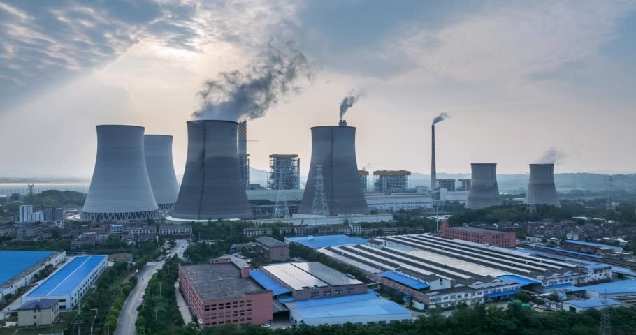 Aerial time-lapse of a large coal-fired power plant at dusk,  traditional grid stabilizer to a modern, flexible partner in the new energy system.