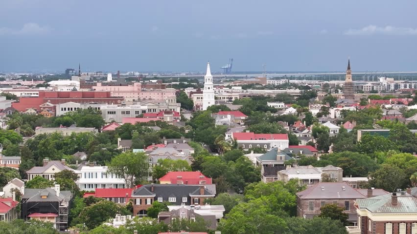 Aerial view of Charleston, South Carolina skyline landscapes with church steeples and downtown historic buildings on Atlantic coast port - 4K Drone