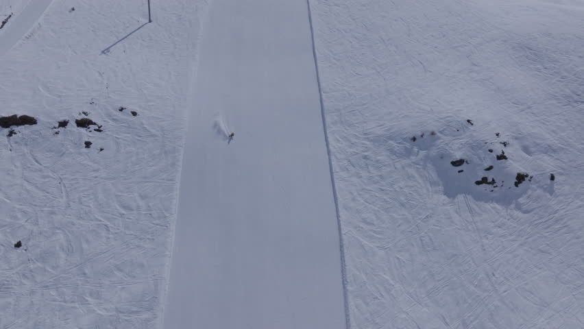High performance alpine ski carving on groomed pistes in Verbier Bruson and Val de Bagnes filmed with drone and follow cam on a bluebird winter day showcasing fast dynamic fun skiing.