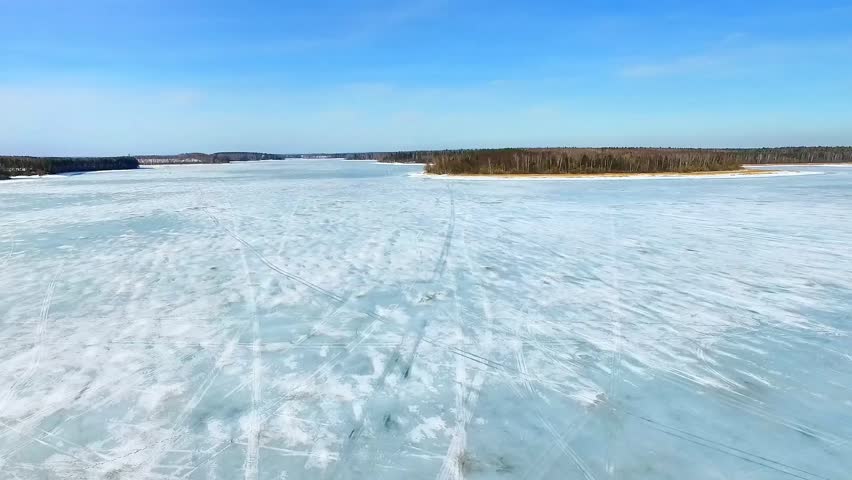 Expansive Frozen Lake Landscape Showcasing Ice, Snow, and Serene Winter Wilderness Beauty in Finland