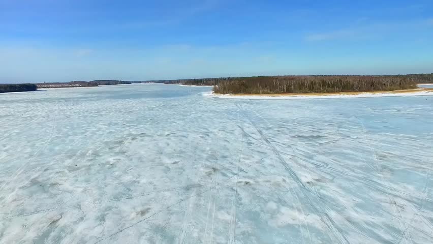 Expansive Frozen Lake Landscape Showcasing Clear Blue Skies and Icy Terrain Under Sunny Daylight in Finland