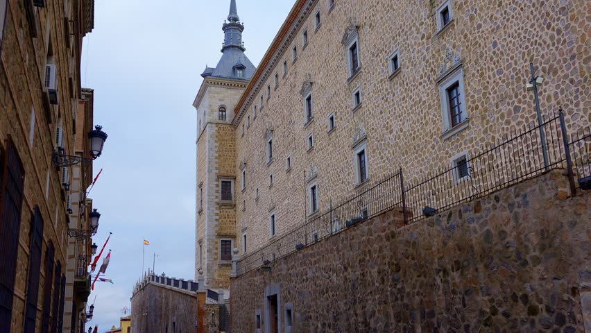 Tower and stone facade of the enormous Alcazar of Toledo in the city of the same name, Spain.