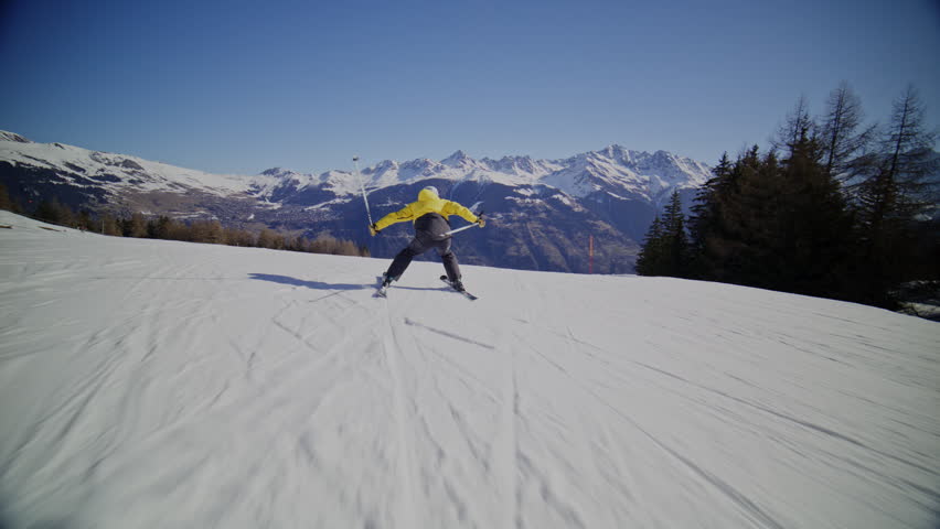 High performance alpine ski carving on groomed pistes in Verbier Bruson and Val de Bagnes filmed with drone and follow cam on a bluebird winter day showcasing fast dynamic fun skiing.