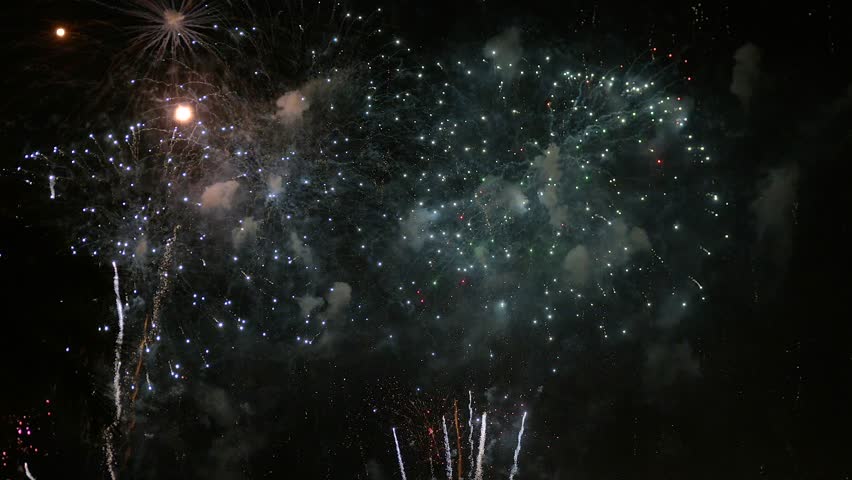 Bright fireworks bursting across night sky