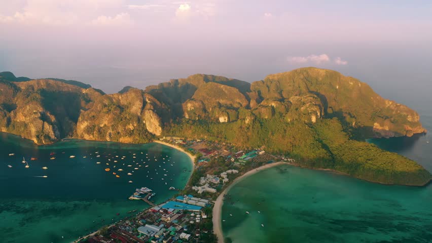 Turquoise water, white sand beaches, boats sailing in Maya bay, Phi Phi island, Thailand.