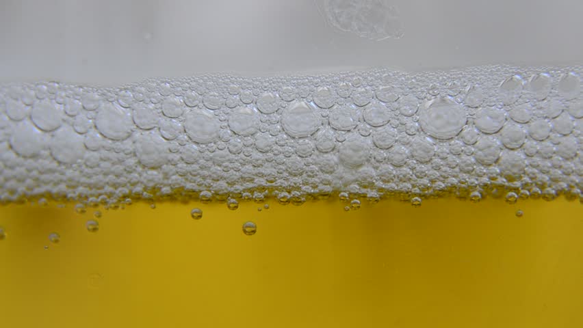 Refreshing Beer, this is a close up of lager! A pint glass is slowly filled with