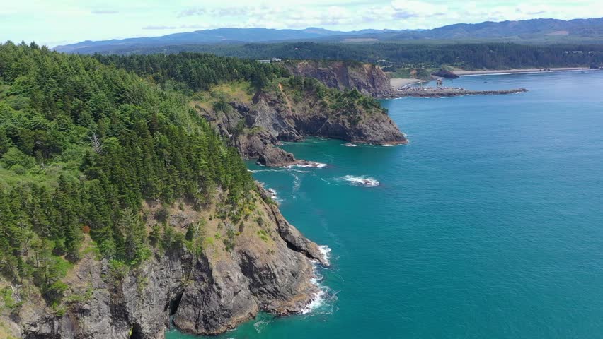 Beautiful aerial drone footage showcasing the dramatic Oregon coastline, with rugged cliffs and serene ocean waves.