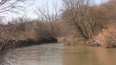 Don Valley River in Toronto, Ontario, Canada. 3 Shots. Includes close-ups of riverbank. Sounds of spring - birds and traffic.