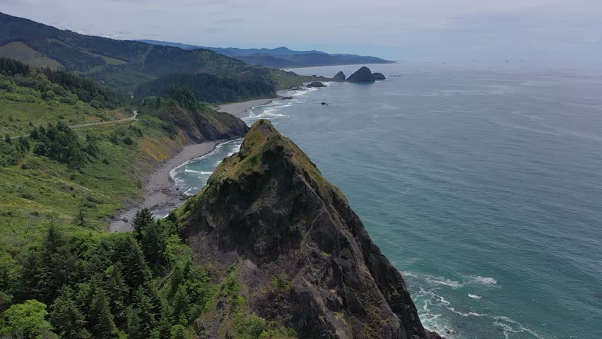 Beautiful aerial drone footage showcasing the dramatic Oregon coastline, with rugged cliffs and serene ocean waves.