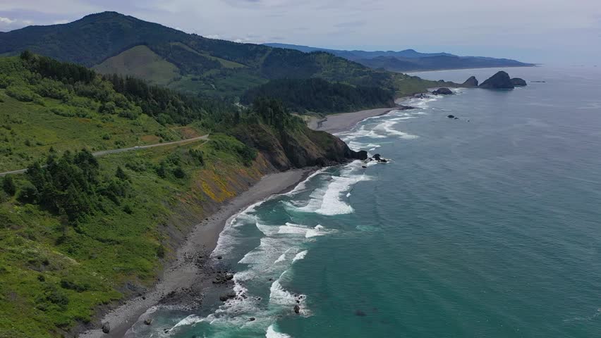 Beautiful aerial drone footage showcasing the dramatic Oregon coastline, with rugged cliffs and serene ocean waves.