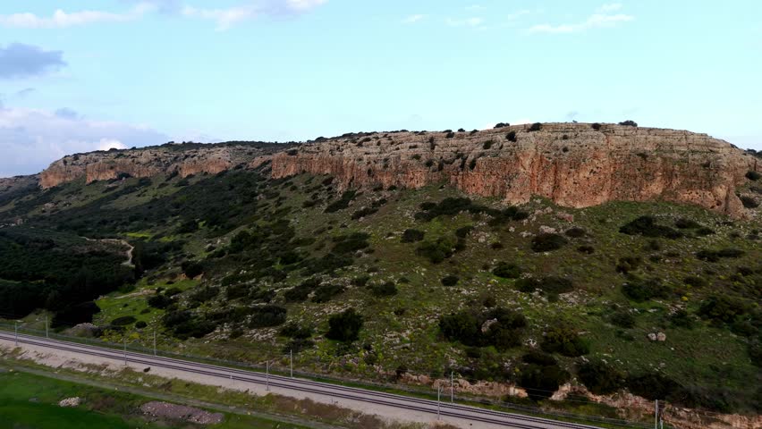 Aerial Drone View of Mount Carmel Ridge Near Binyamin, Green Fields, Road and Mediterranean Sea, Israel