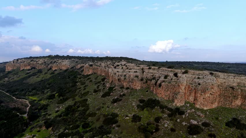 Aerial Drone View of Mount Carmel Ridge Near Binyamin, Green Fields, Road and Mediterranean Sea, Israel