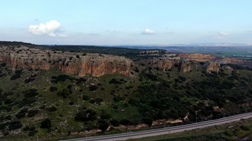 Aerial Drone View of Mount Carmel Ridge Near Binyamin, Green Fields, Road and Mediterranean Sea, Israel