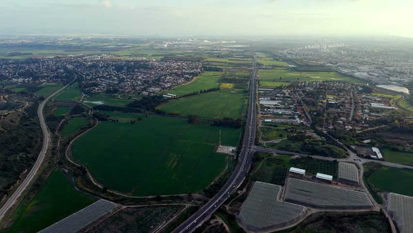 Aerial Drone View of Mount Carmel Ridge Near Binyamin, Green Fields, Road and Mediterranean Sea, Israel