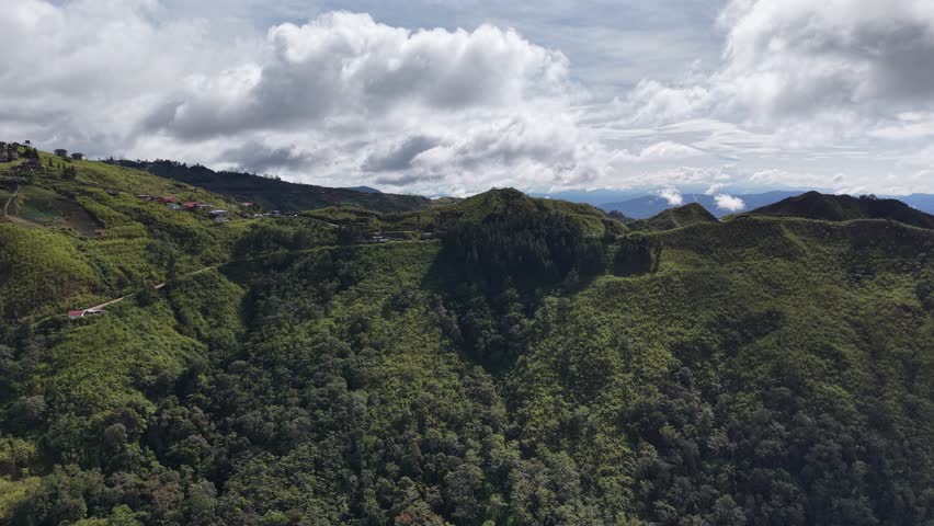Mount Kinabalu rising through the clouds - a granite giant holding Sabah’s sky in its hands, where every step feels like walking toward the edge of the world	