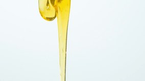 Macro slow motion of liquid natural honey flow on white background. - Powered by Shutterstock - Get 15% off with code: PIKWIZARD15