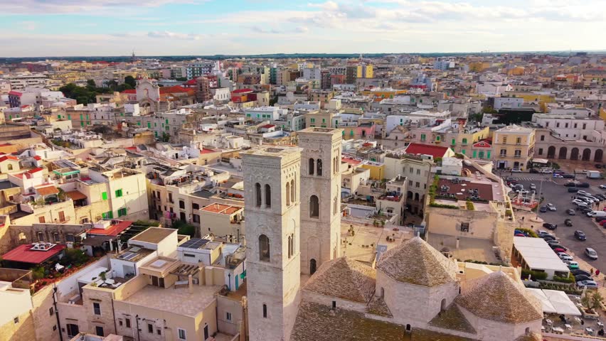 Aerial view of coastal town with buildings near blue sea.