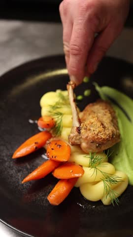 The chef decorates dishes in the restaurant. Close-up.