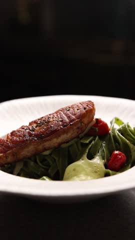 The chef decorates dishes in the restaurant. Close-up.